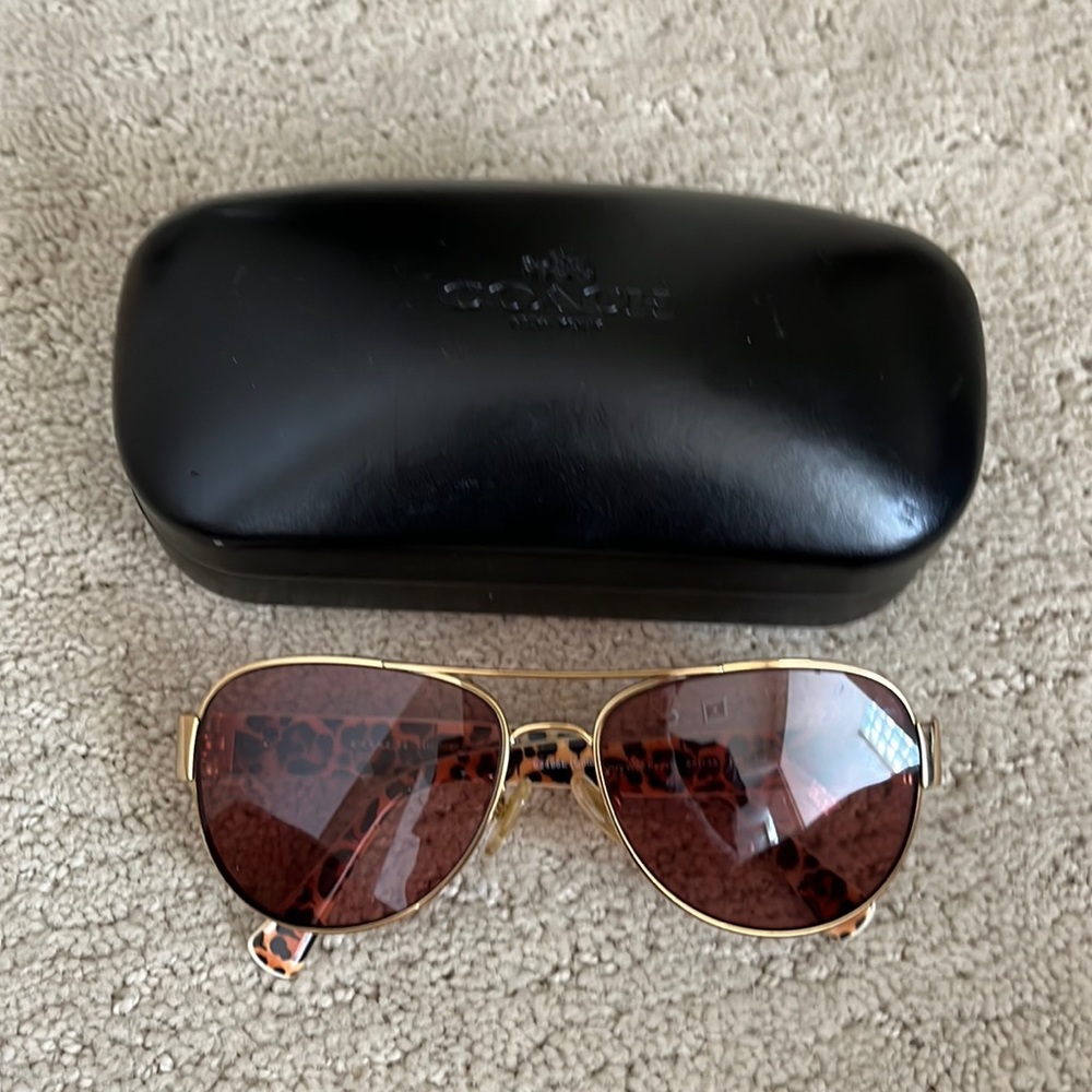 Coach Sunglasses with black case. Has a prescription in the lenses.